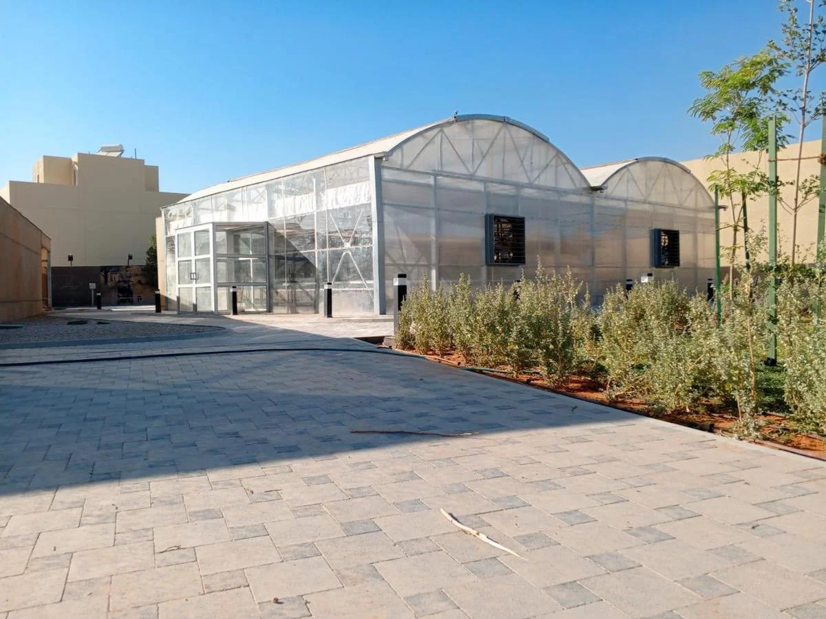 UID-built greenhouse exterior with lawn