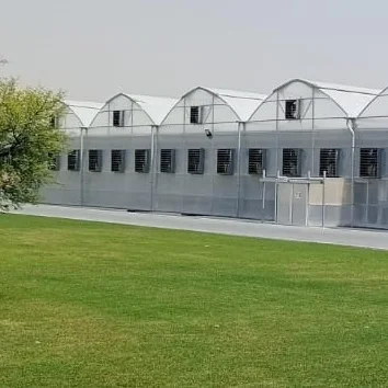 UID greenhouse with glass doors under a blue sky
