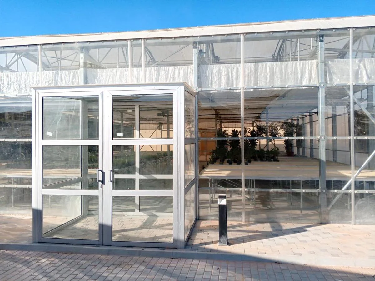 Aluminium and glass entrance of a UID greenhouse